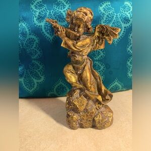 Rococo candleholder of winged cherub playing flute